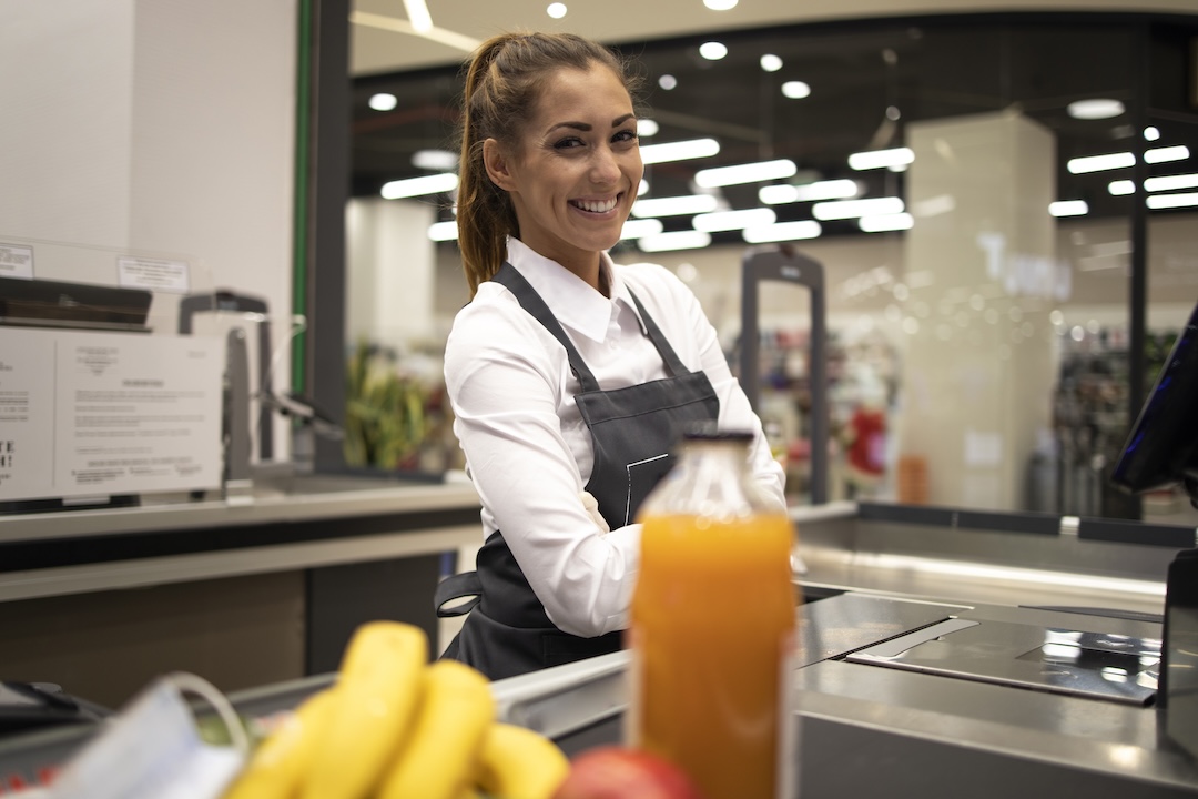 Responsable caisse en hypermarché, symbole de la planification terrain avec Aionos et PHENICIA